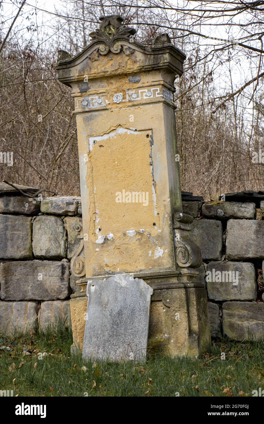 A damaged tombstone in the cemetery Stock Photo