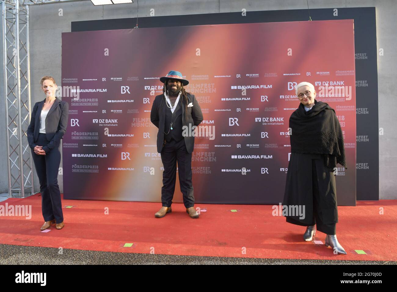 Munich, Germany. 09th July, 2021. The jury Sophie von Kessel, actress, (l-r) Komi M. Togbonou, actor and Münchner Kammerspiele ensemble member and Barbara Mundel, artistic director of Münchner Kammerspiele arrive at the award ceremony of the New German Cinema Award in front of the University of Television and Film. The award is presented in several categories such as directing, acting, screenplay or production and is endowed with a total of 70,000 euros. The prize sponsors are Bayerischer Rundfunk, Bavaria Film and DZ Bank. Credit: Felix Hörhager/dpa/Alamy Live News Stock Photo