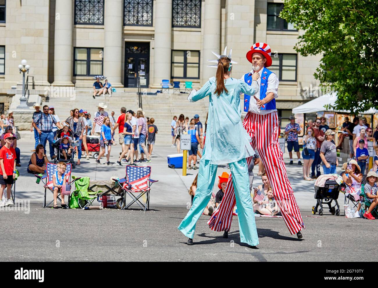 Prescott, Arizona, USA - July 3, 2021: Man and woman on stilts dressed in costume  in the 4th of July parade Stock Photo