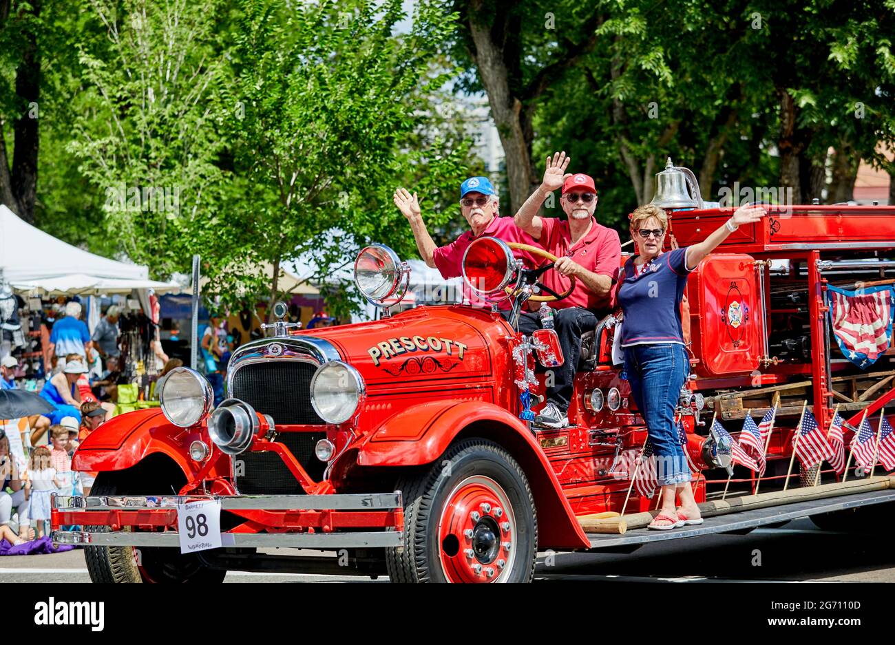 Prescott, Arizona, USA - July 3, 2021: Participants riding on an antique fire truck waving to the spectators in the 4th of July parade Stock Photo