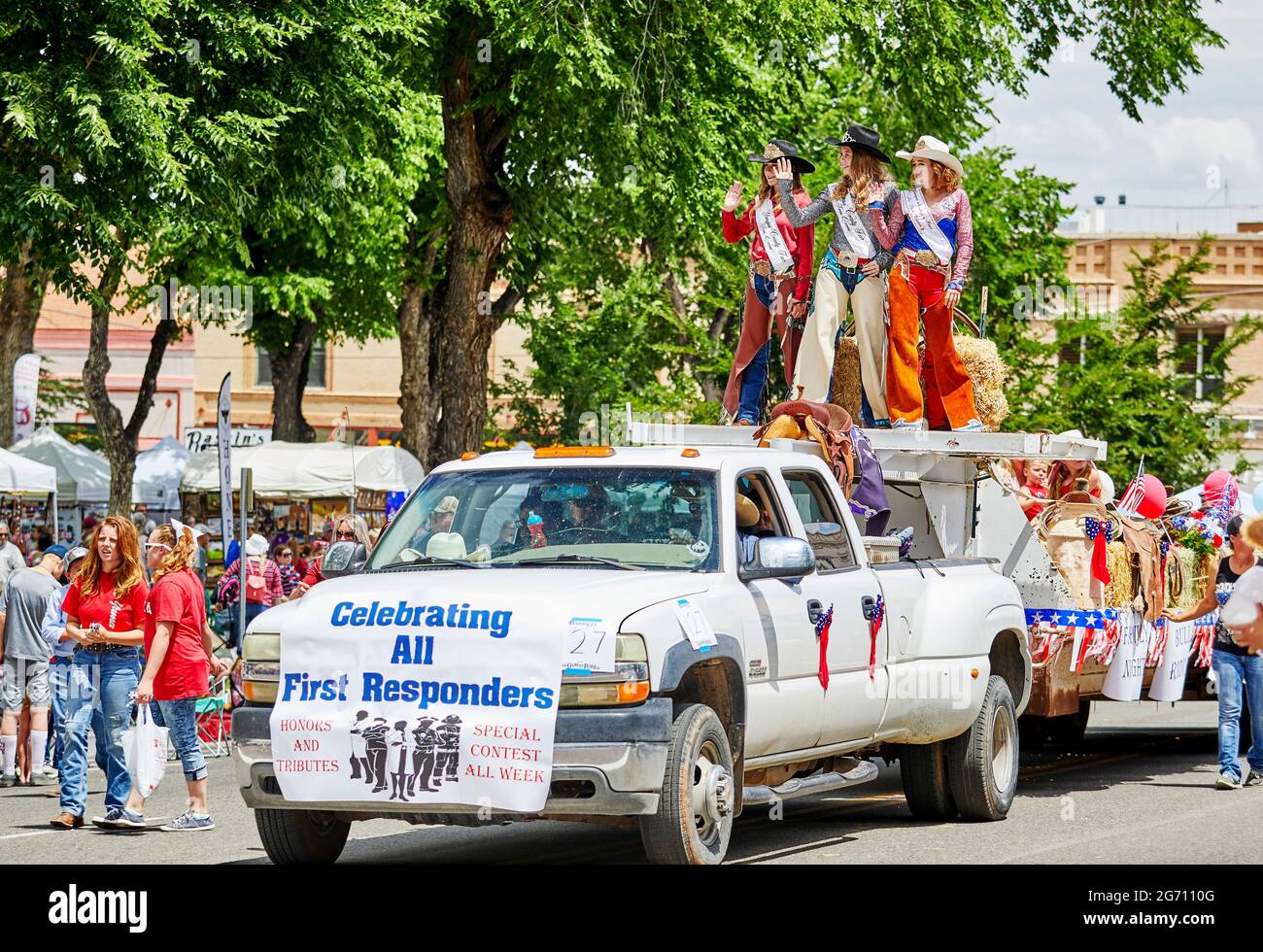 Prescott, Arizona, USA - July 3, 2021: Particpants riding on and float and waving to the spectators in the 4th of July parade Stock Photo