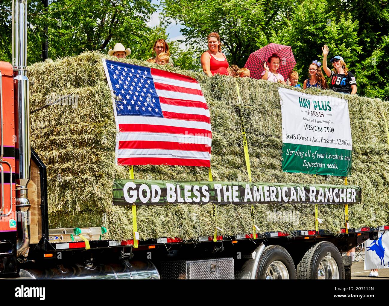 Prescott, Arizona, USA - July 3, 2021: Truck carrying hay bales representing American ranchers in the 4th of July parade Stock Photo