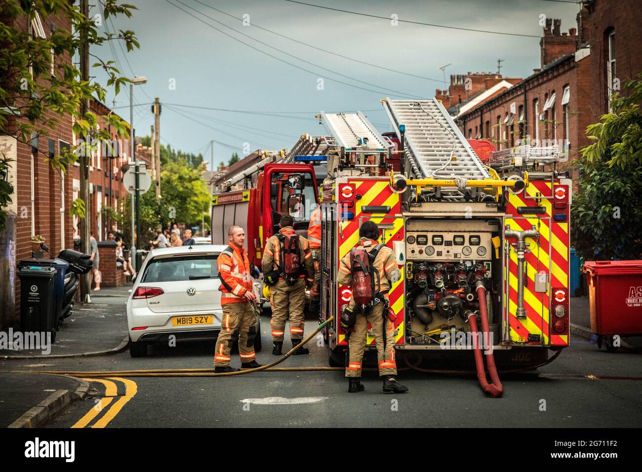 Manchester, UK. 09th July, 2021. Firefighters control the pump for the water at the firefighting truck.Greater Manchester Fire Service block off Norman Street, Failsworth after a house fire in a flat on Manchester Road. Residents say the house fire was caused by a man who wanted to commit suicide however conflicting reports also came me that the man was cooking. Two fire trucks and a fire commander responded to the scene. Credit: SOPA Images Limited/Alamy Live News Stock Photo