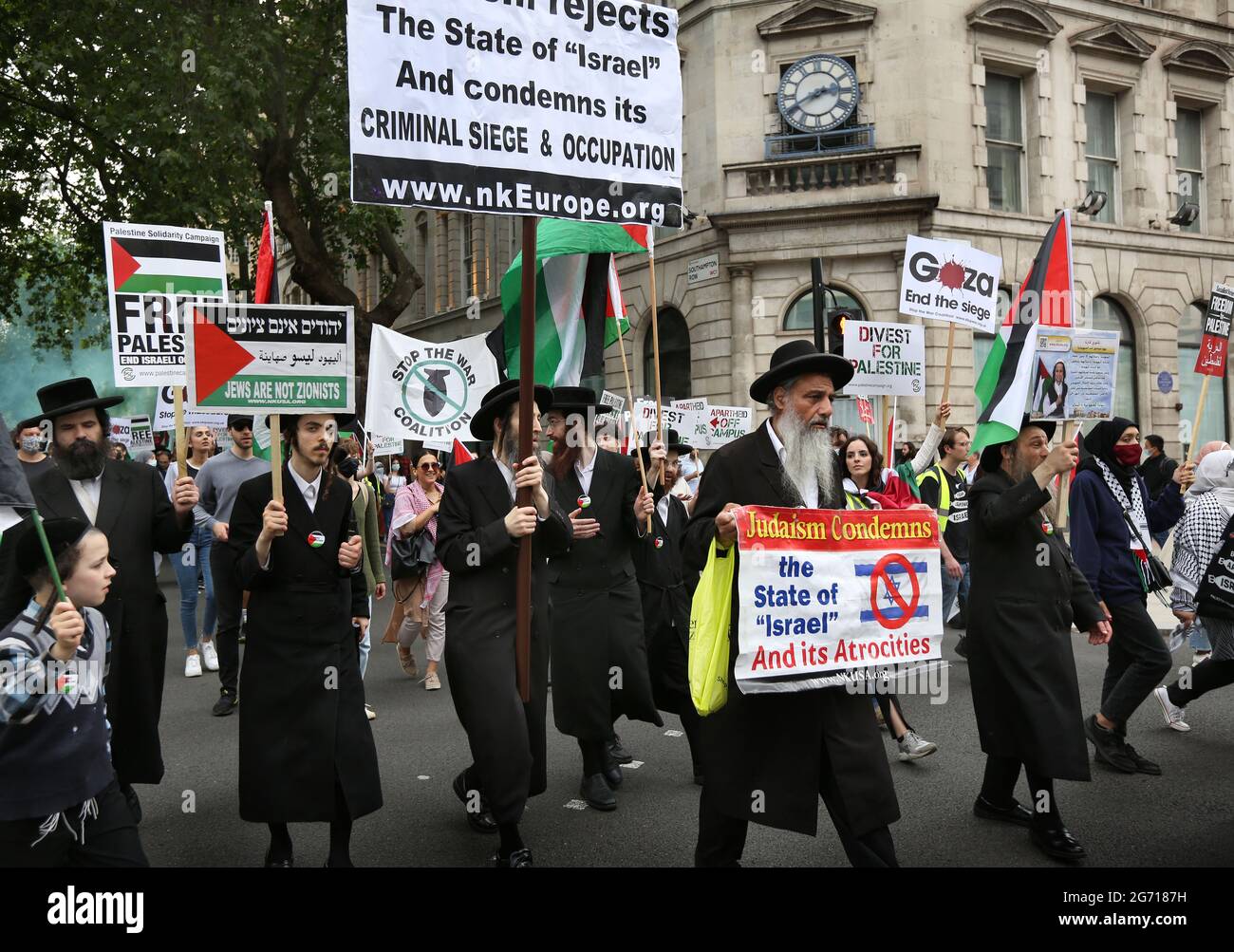 London, UK. 09th July, 2021. Protesters from the orthodox Jewish anti-Zionist group the Neturei Karta hold Palestinian flags and placards during a protest.Students and other protesters go on a tour of London Universities to demand a boycott for all Israeli academic and cultural institutions in solidarity with the struggle to end Israel's occupation, colonisation and system of apartheid in Israel. Credit: SOPA Images Limited/Alamy Live News Stock Photo