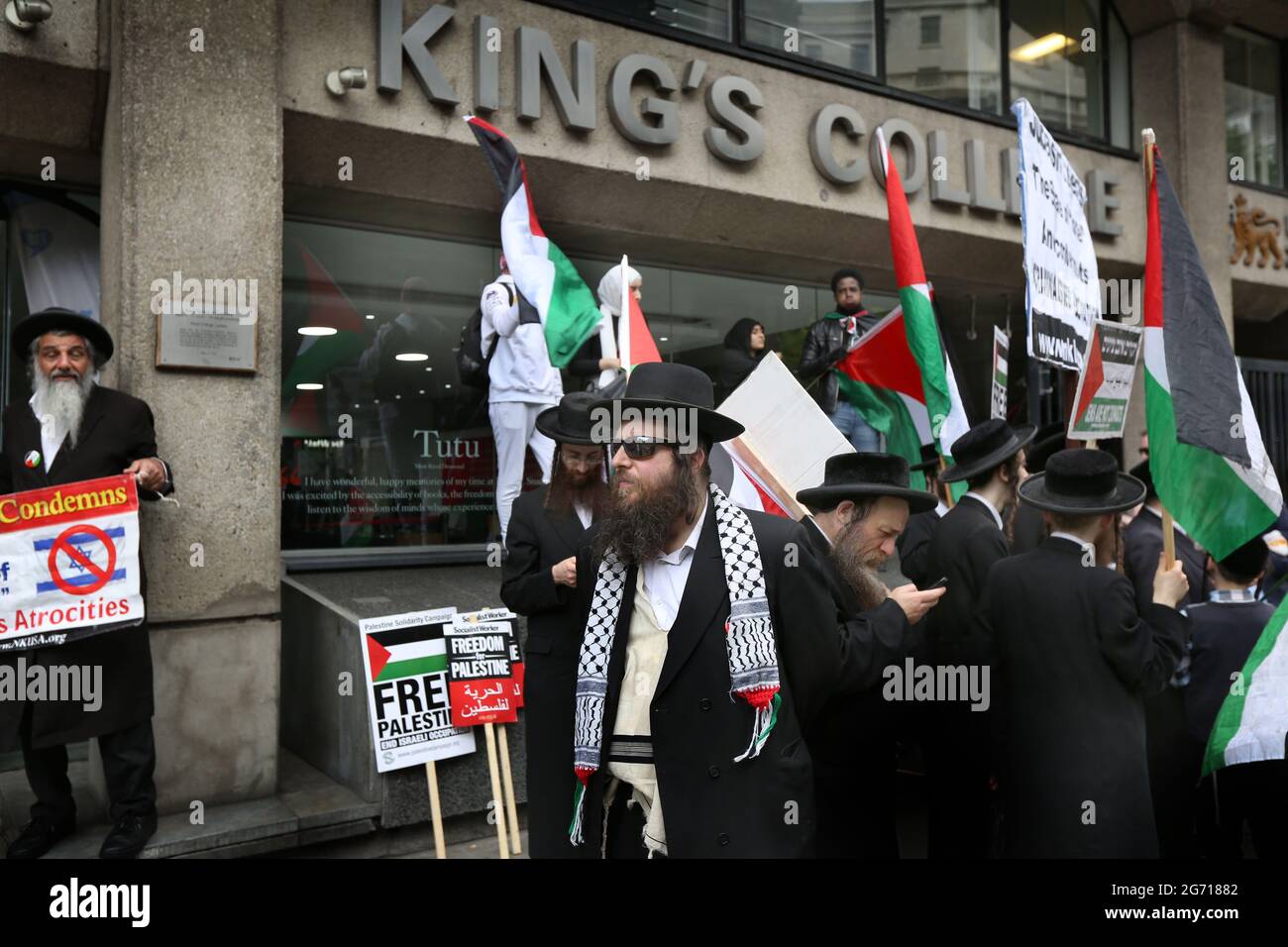 London, UK. 09th July, 2021. Protesters from the orthodox Jewish anti-Zionist group the Neturei Karta hold Palestinian flags and placards outside King's College during a protest.Students and other protesters go on a tour of London Universities to demand a boycott for all Israeli academic and cultural institutions in solidarity with the struggle to end Israel's occupation, colonisation and system of apartheid in Israel. Credit: SOPA Images Limited/Alamy Live News Stock Photo