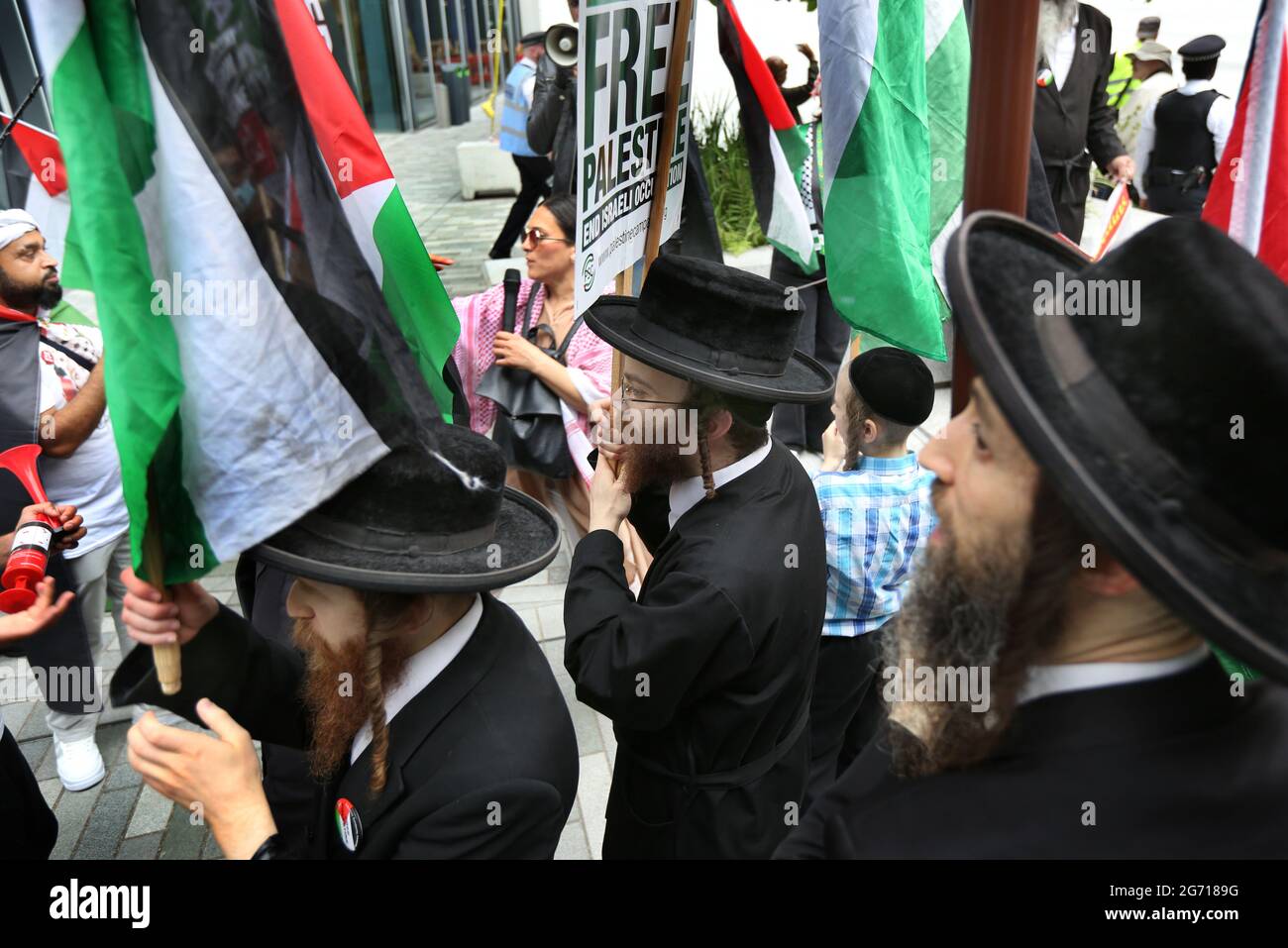 London, UK. 09th July, 2021. Protesters from the orthodox Jewish anti-Zionist group the Neturei Karta hold Palestinian flags and placards during a protest outside the London School of Economics.Students and other protesters go on a tour of London Universities to demand a boycott for all Israeli academic and cultural institutions in solidarity with the struggle to end Israel's occupation, colonisation and system of apartheid in Israel. Credit: SOPA Images Limited/Alamy Live News Stock Photo
