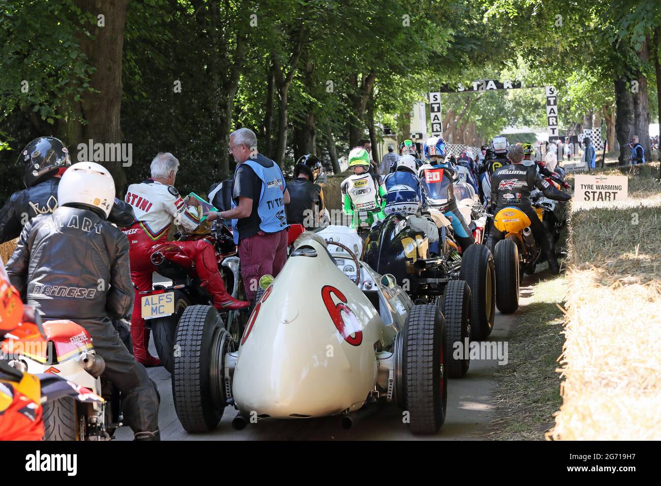Goodwood, West Sussex, UK. 9th July 2021. Giacomo Agostini multiple motorcycle Grand Prix World Champion signs an autograph while awaiting his ride up the hillclimb at the Goodwood Festival of Speed – ‘The Maestros – Motorsports Great All-Rounders’, in Goodwood, West Sussex, UK. © Malcolm Greig/Alamy Live News Stock Photo