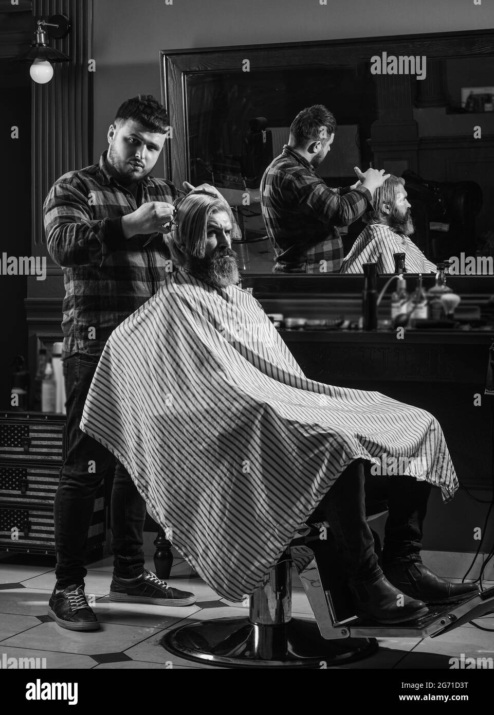 Cut hair. Barber hairstyle barbershop. Professional cosmetics. Hipster getting haircut. Healthy hair. Annoy barber could turn out poorly for your ear Stock Photo