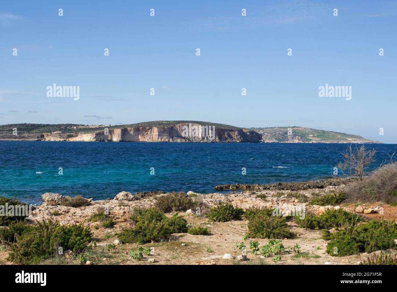 MARSAXLOKK, MALTA - 01 JAN, 2020: View to the island Gozo from rocky cliffs of the island of Malta Stock Photo
