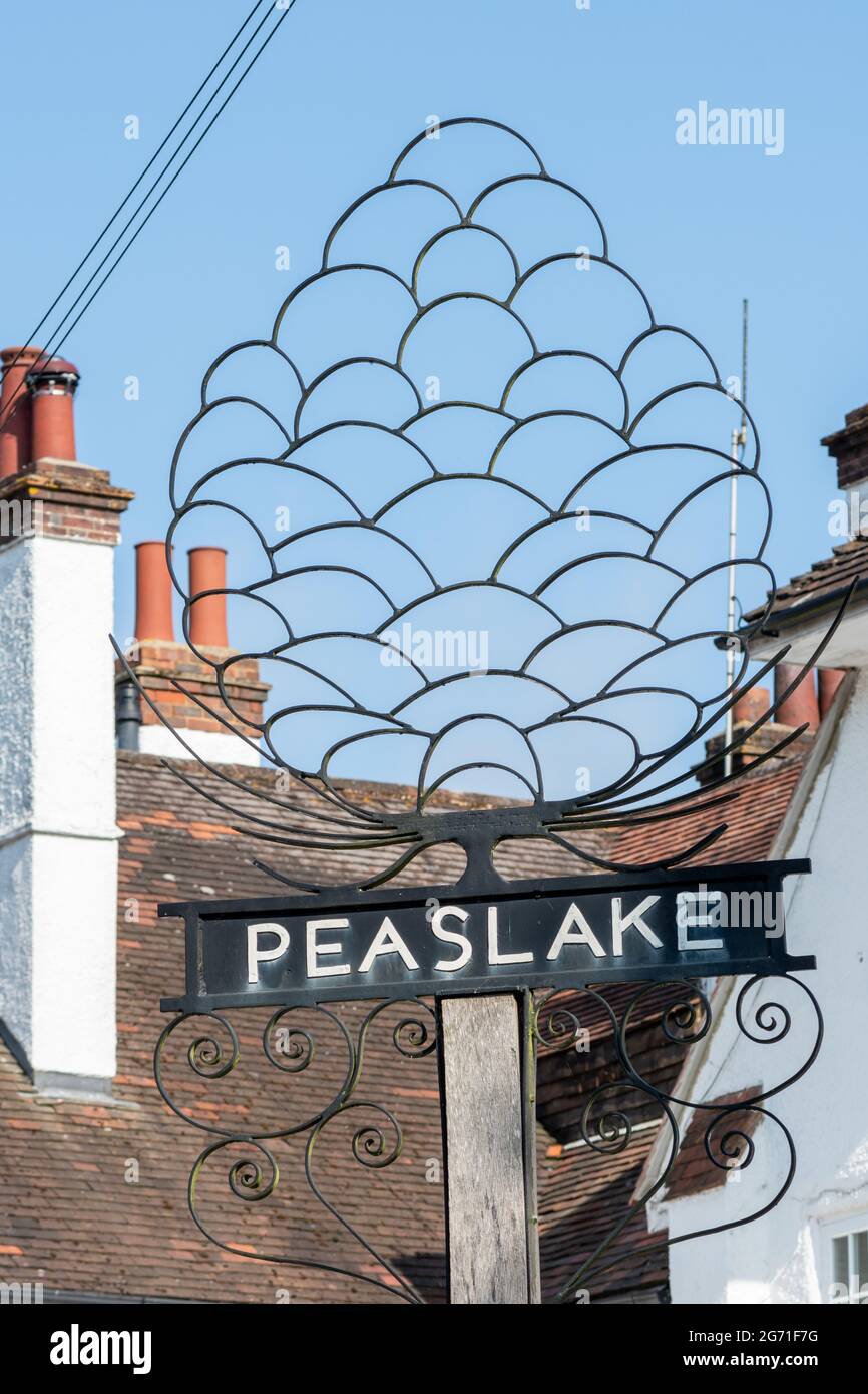 Village sign in Peaslake, pretty village in the Surrey Hills AONB, England, UK Stock Photo