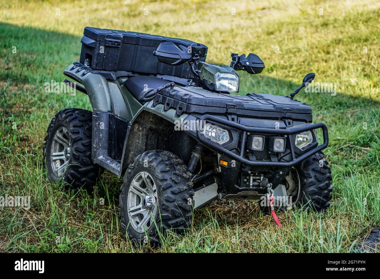 ATV quad bike on a background of green grass. Four-wheeled motorcycle 4x4  for sports and recreation. Off-road transport Stock Photo - Alamy