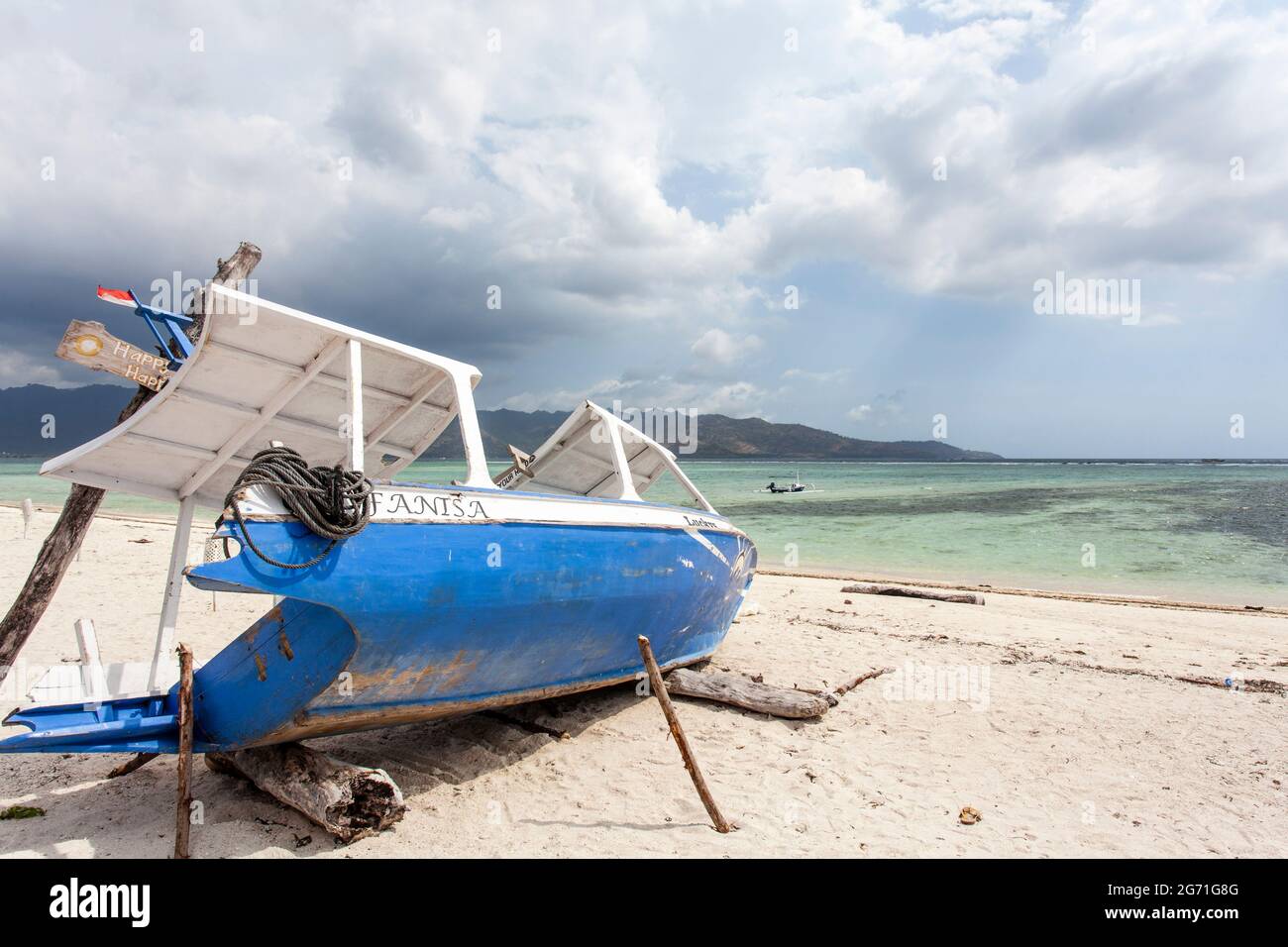 Blue and white fishing boat on the beach of Gili Air, Indonesia ...