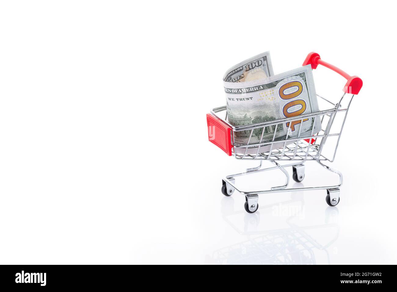 Shopping cart with 100 US dollars inside, isolated on white background Stock Photo