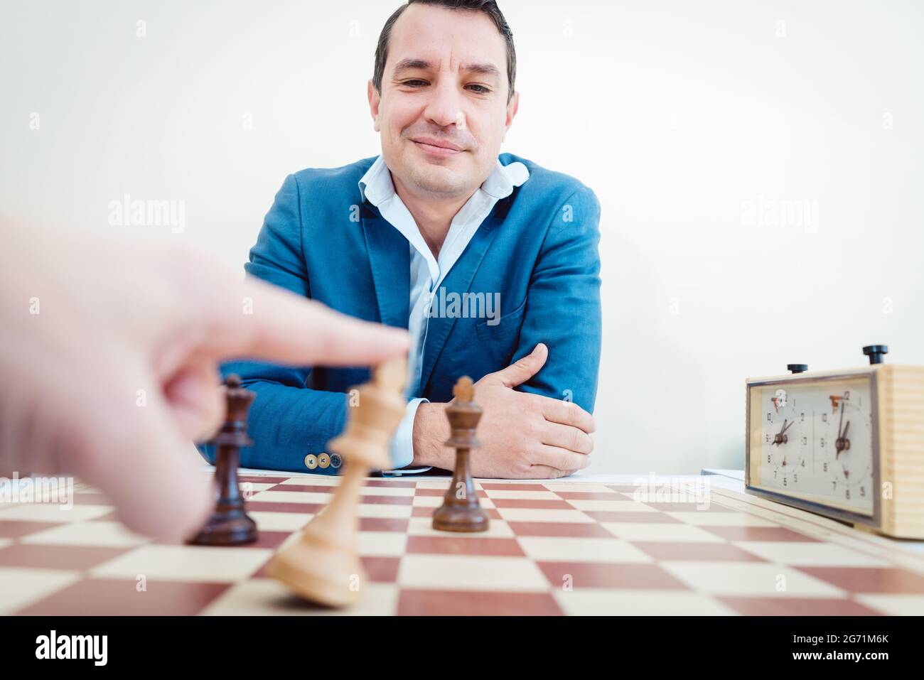 man setting woman checkmate, she is accepting defeat Stock Photo