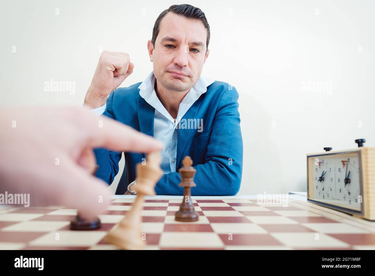 man setting woman checkmate, she is accepting defeat Stock Photo