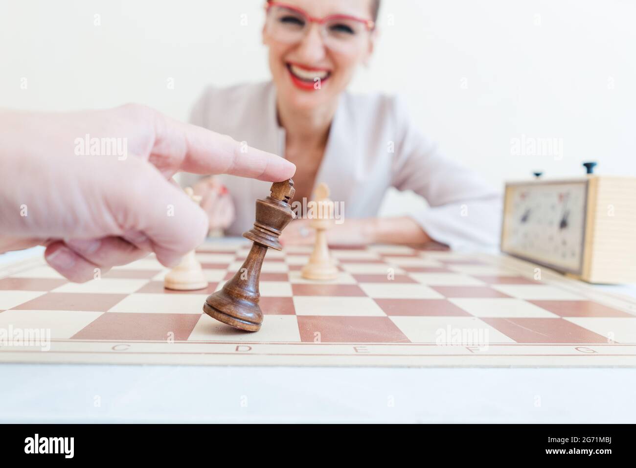 Man loosing game of chess against business woman accepting defeat Stock Photo