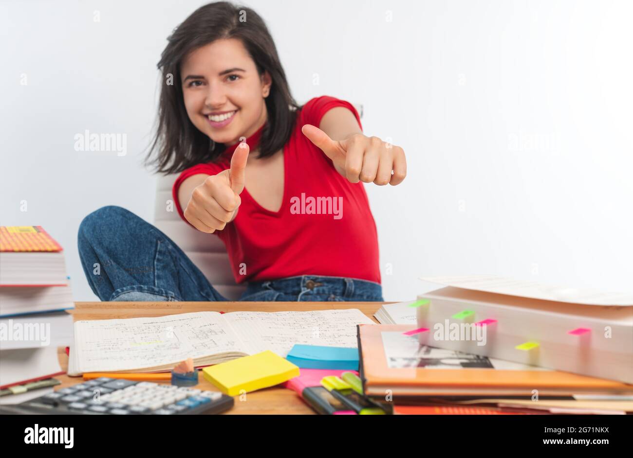 Portrait of a smiling girl showing thumb up at camera Stock Photo - Alamy
