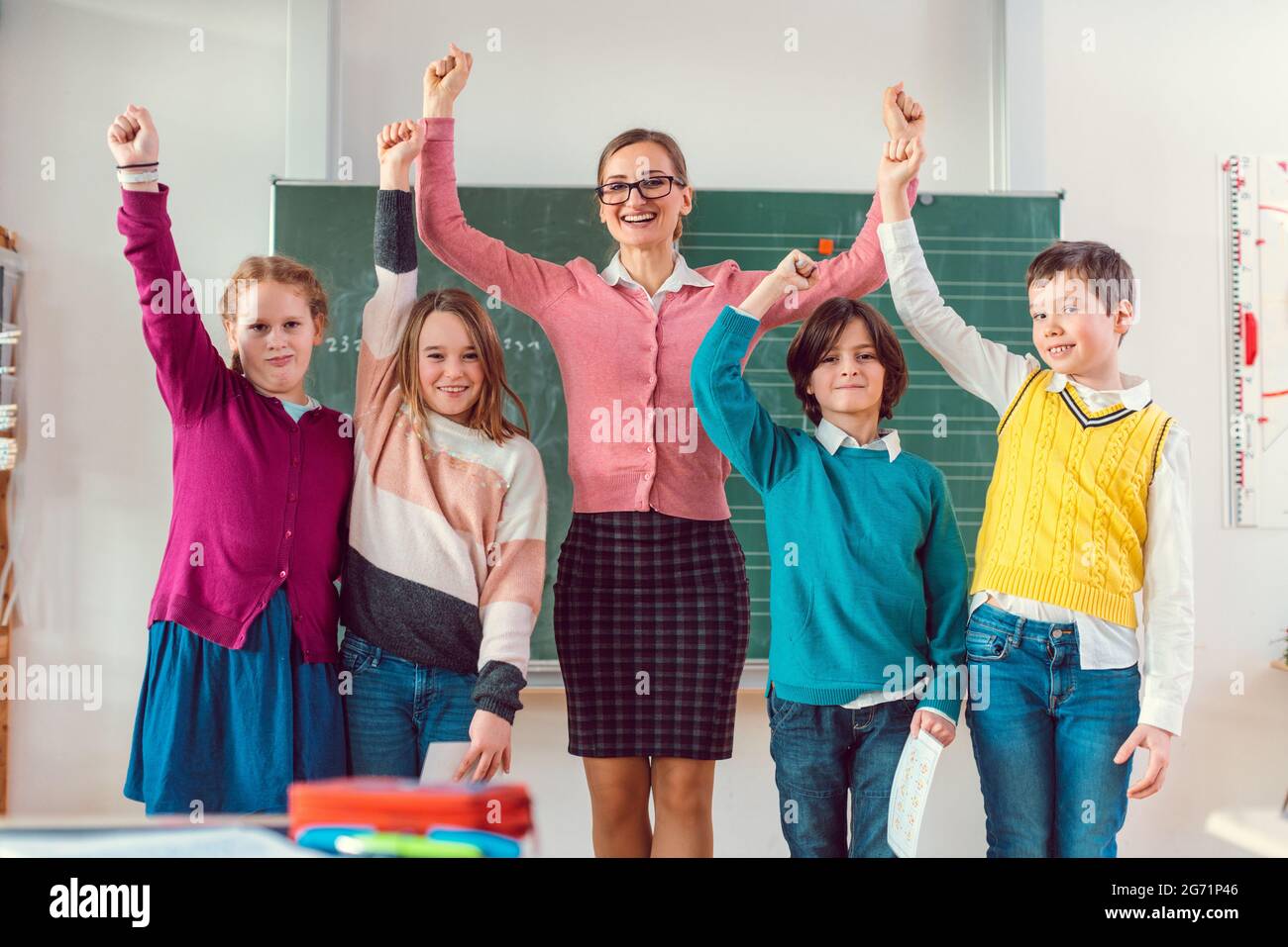 Students and teacher having fun in school jumping in class Stock Photo Alamy