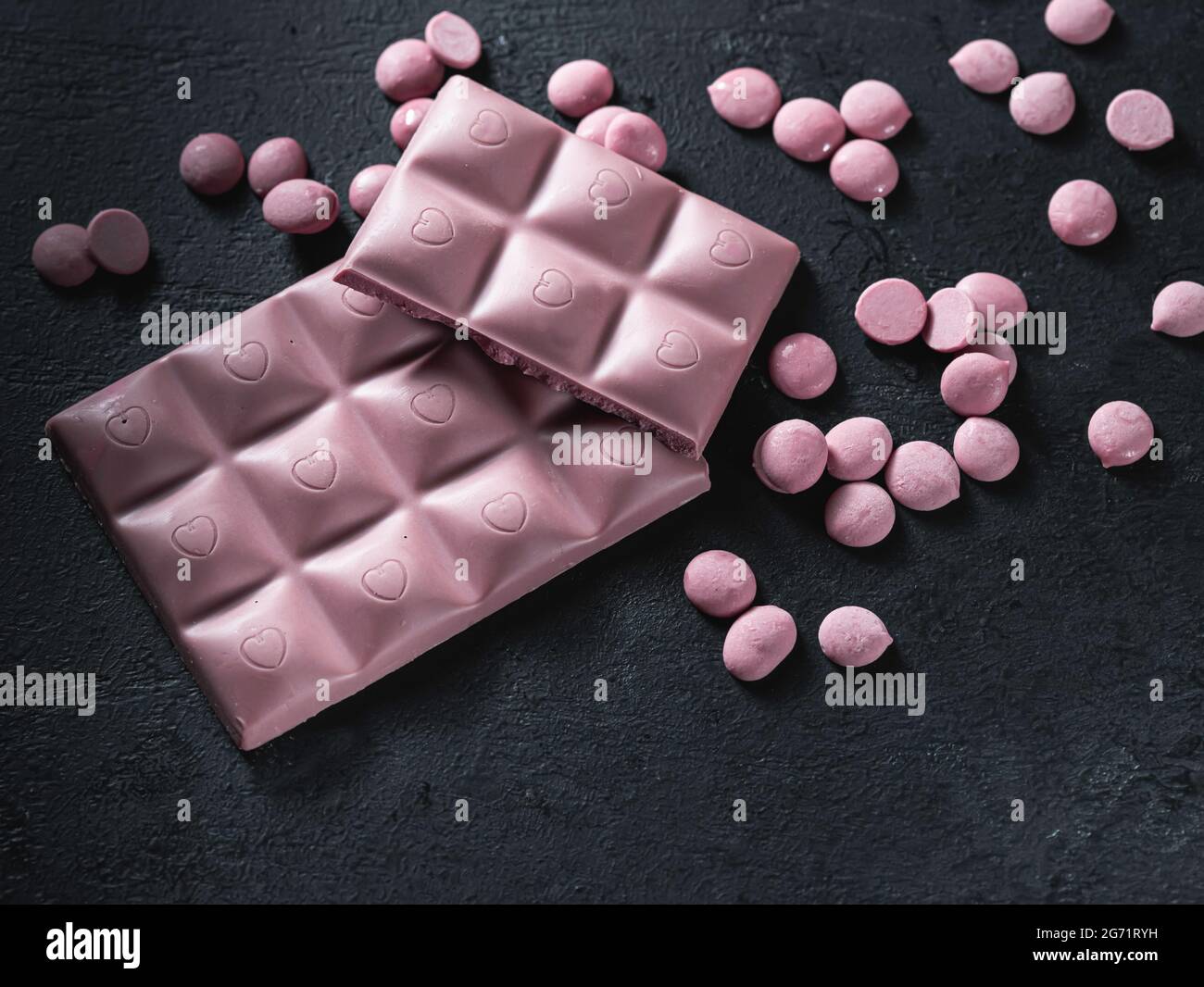 Pink chocolate on a black background. Ruby chocolate. The fourth type in chocolate. Selective focus Stock Photo