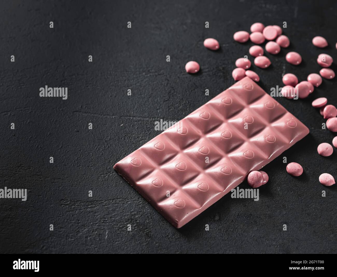 Pink chocolate on a black background. Ruby chocolate. The fourth type in chocolate. Selective focus Stock Photo