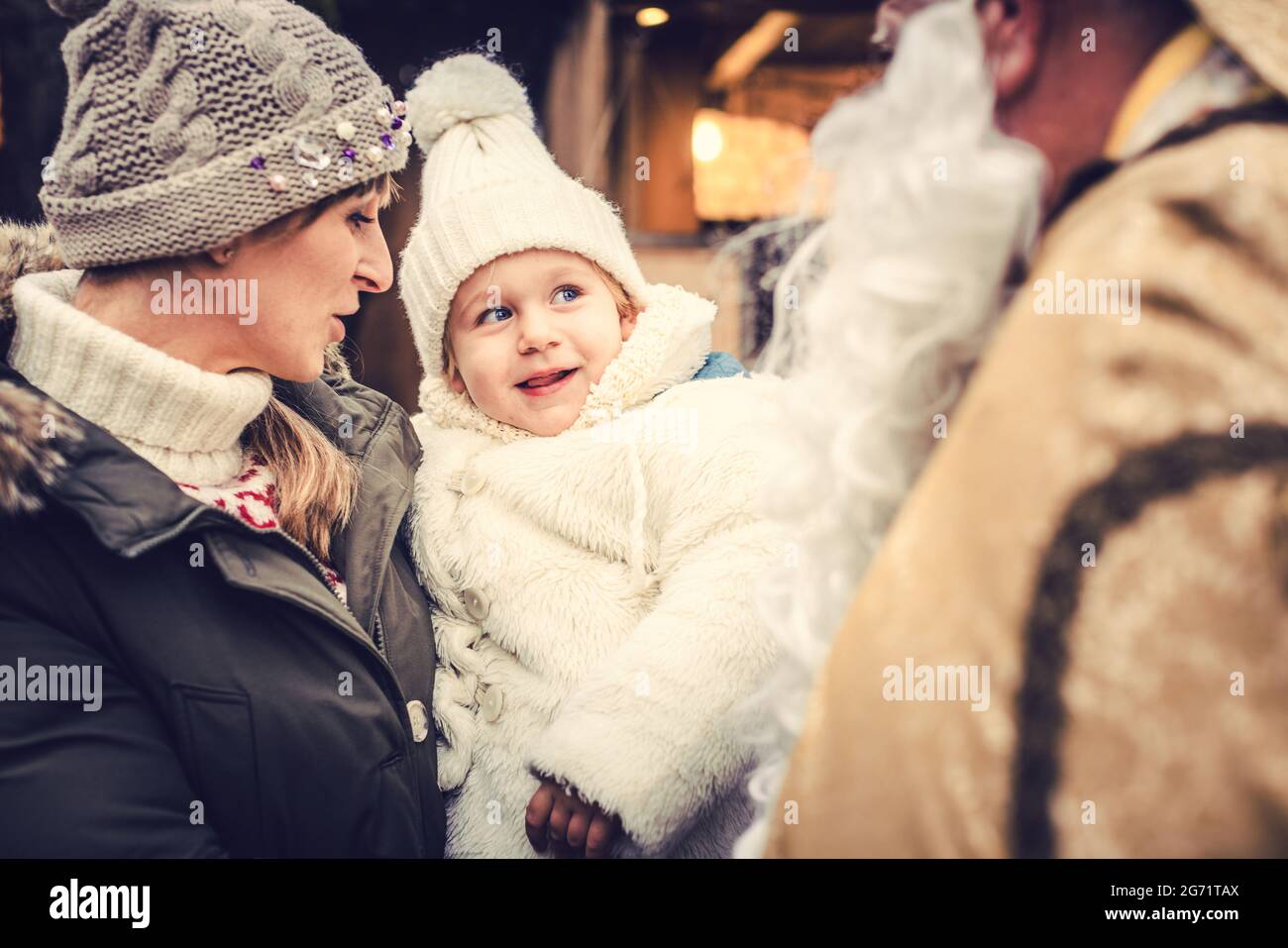 Little girl child meeting St Nicholas at a Christmas market Stock Photo