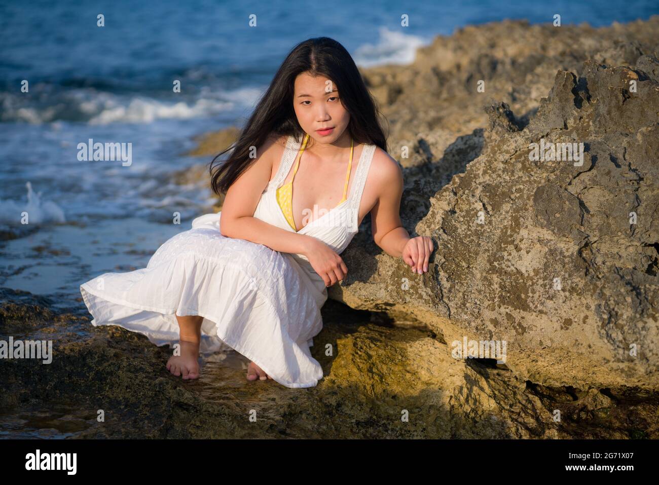 young happy and beautiful Asian woman by the sea - Attractive Korean girl  in white dress enjoying relaxed summer holidays at tropical island in  travel Stock Photo - Alamy
