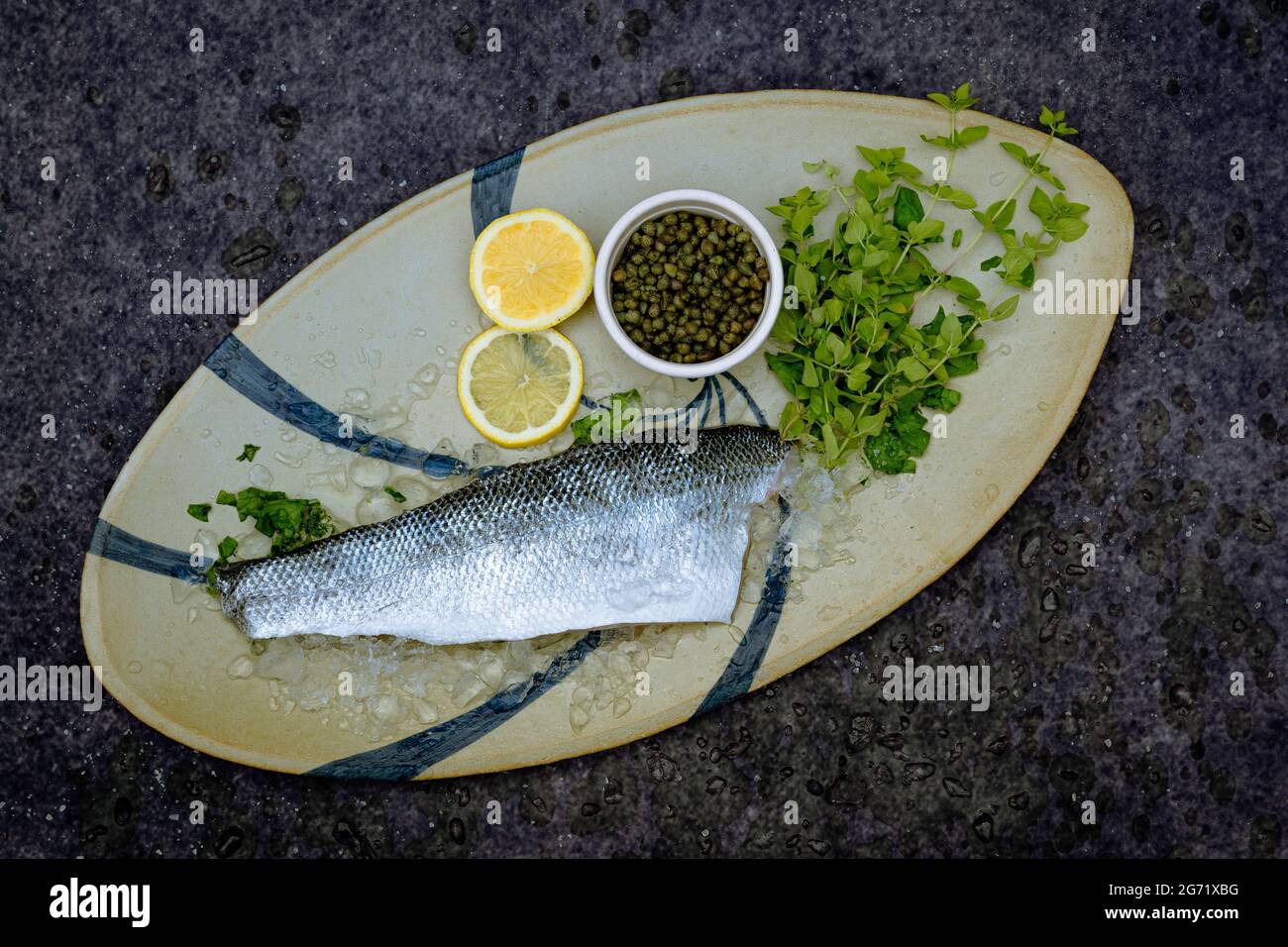 Fresh sea bass caught off the coast of Dorset, on oval Spanish pottery