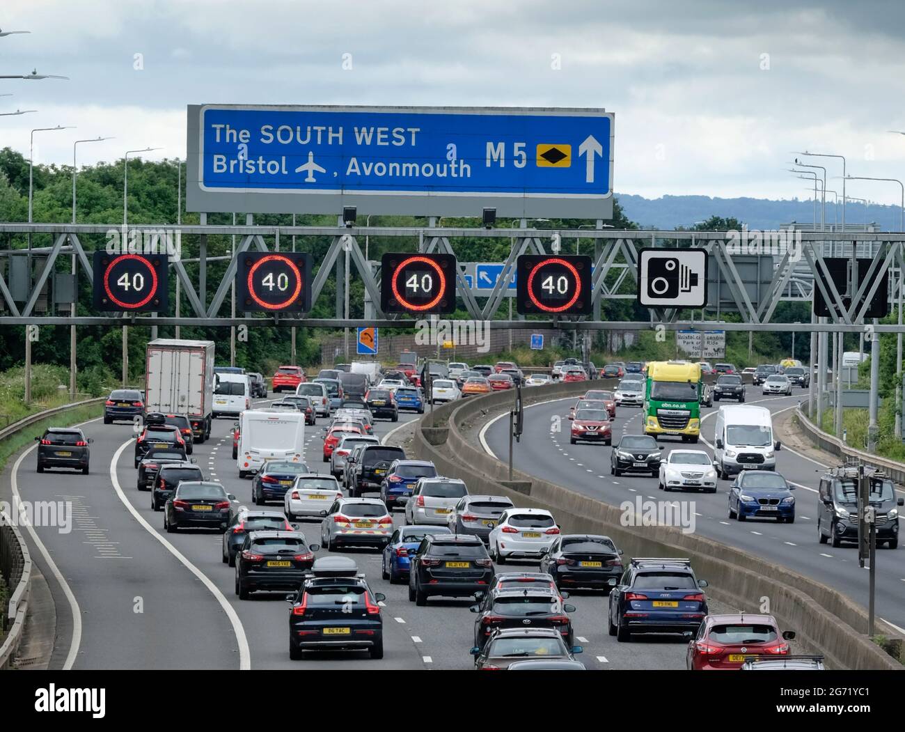 Bristol, UK. 10th July, 2021. Highways England report average speeds below 30 MPH. Managed motorway speed restrictions are in place on the M5 motorway at Filton due to the volume of traffic heading south towards popular staycation destinations Somerset, Devon and Cornwall. Credit: JMF News/Alamy Live News Stock Photo