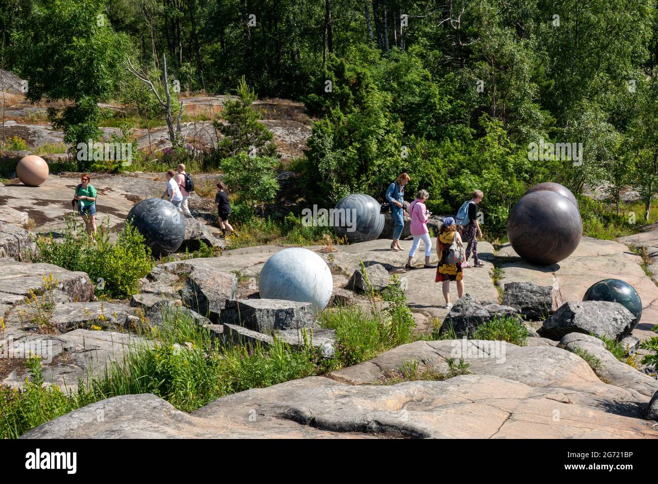 Large stone globes, part of Pars Pro Toto sculpture by Alicja Kwade at Helsinki Biennial 2021 art event in Vallisaari Island of Helsinki, Finland Stock Photo