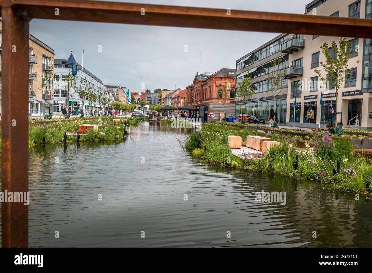 Randers, Denmark - 10-July-2021: The new rainwater basin at Ostervold in Randers, People look at flowers and nature, street resturant. Stock Photo