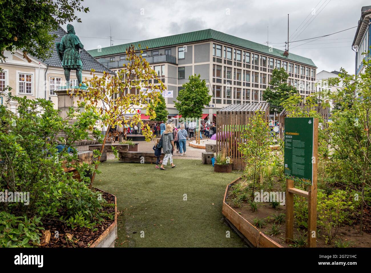 Randers, Denmark - 10 July 2021: The square in front of Randers town hall, square with flowers and benches, people enjoying themselves on the square Stock Photo