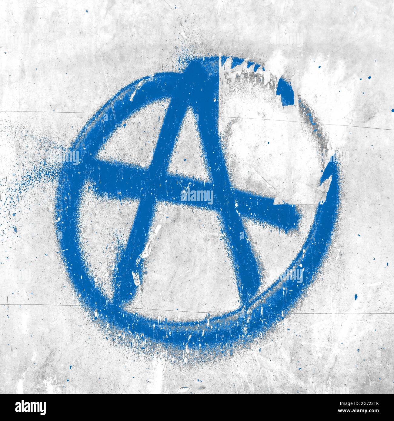 Blue symbol of anarchy painted on the peeling old wall. Ideal for textures, backgrounds and concepts. Stock Photo