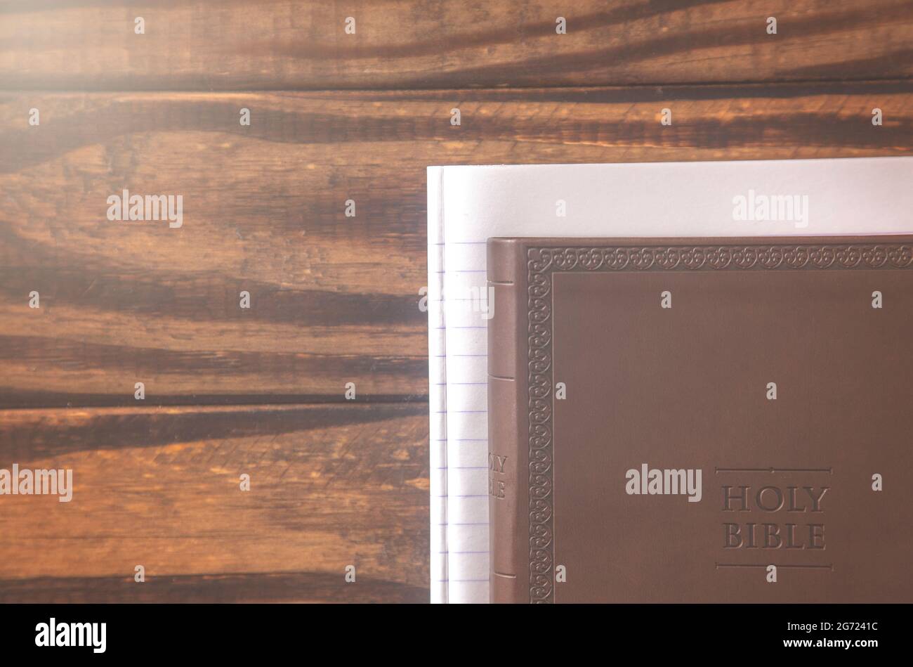 Background with a Bible on a Rustic Wooden Table Stock Photo - Alamy