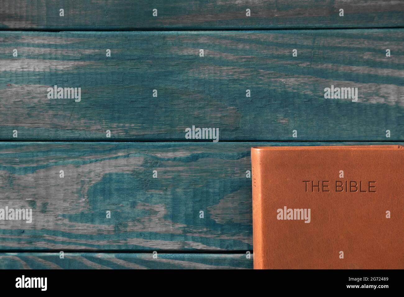 Background with a Bible on a Rustic Wooden Table Stock Photo - Alamy