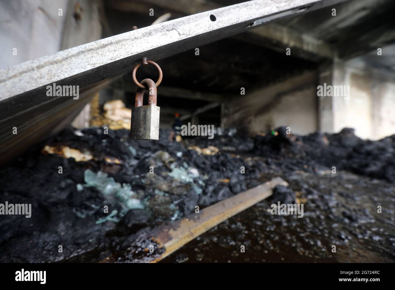 July 10, 2021.Dhaka,Bangladesh: Bangladeshi firefighters remove fire in burnt rubble and searching missing bodies after in a fire at the factory of Ha Stock Photo