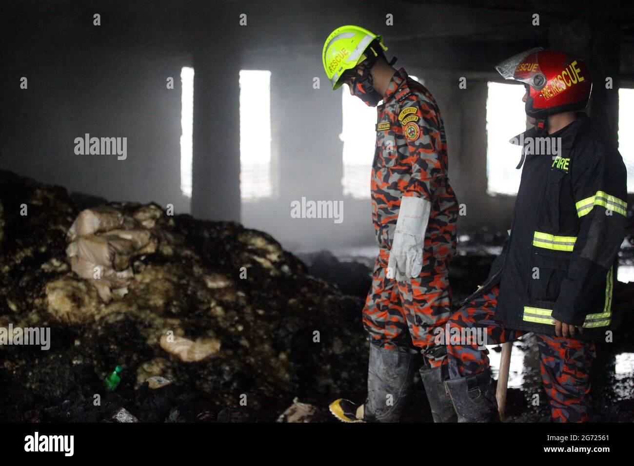 July 10, 2021.Dhaka,Bangladesh: Bangladeshi firefighters remove fire in burnt rubble and searching missing bodies after in a fire at the factory of Ha Stock Photo