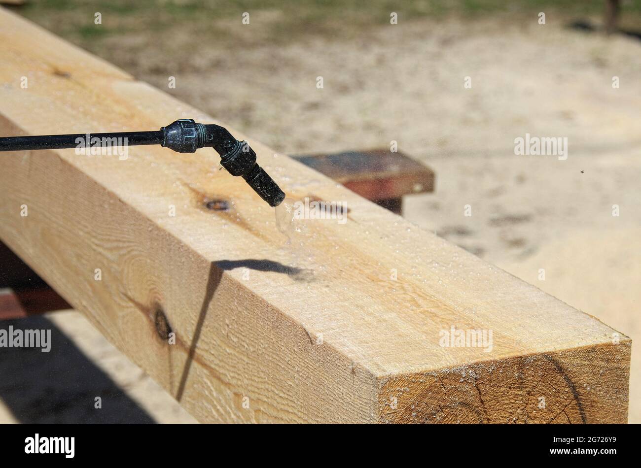 spraying wood preservative. protection of wood from mold. processing of timber with a chemical composition. Stock Photo