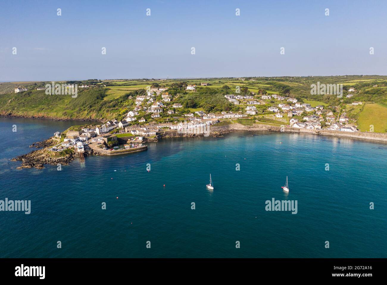 COVERACK, CORNWALL, UK - JUNE 29, 2021.  Aerial seascape view of the picturesque bay and fishing village of Coverack in Cornwall, UK Stock Photo