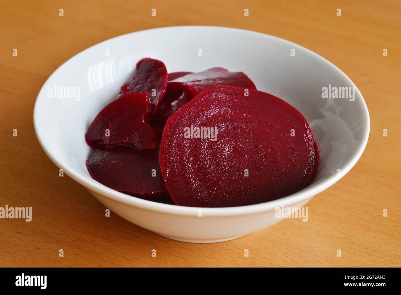 Red beet salad in bowl on wooden background Stock Photo