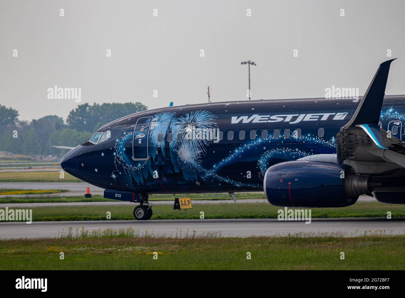 Montreal, Quebec, Canada - 07 07 2021: Westjet's Walt Disney World livery on their 737-8CT landing in Montreal. Registration C-GWSZ Stock Photo