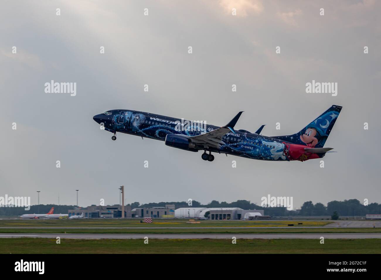 Montreal, Quebec, Canada - 07 07 2021: Westjet's Walt Disney World livery on their 737-8CT taking off from Montreal. Registration C-GWSZ Stock Photo