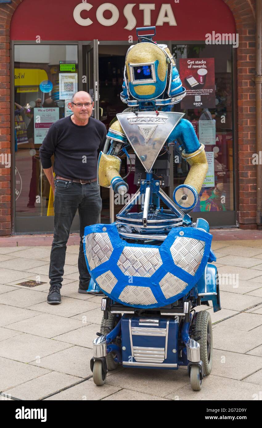 Christchurch, Dorset UK. 10th July 2021. Sparky the Robot, a genuine robot  with no human parts and tons of personality entertains the crowds at  Christchurch, Dorset, as part of the Arts by