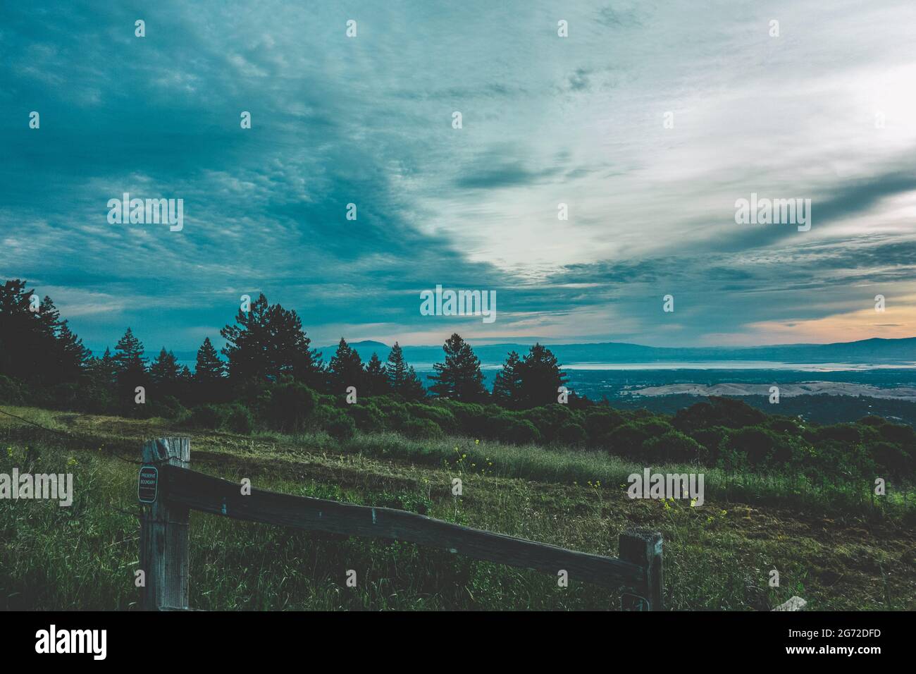 Landscape of hills covered in greenery under a blue cloudy sky Stock ...