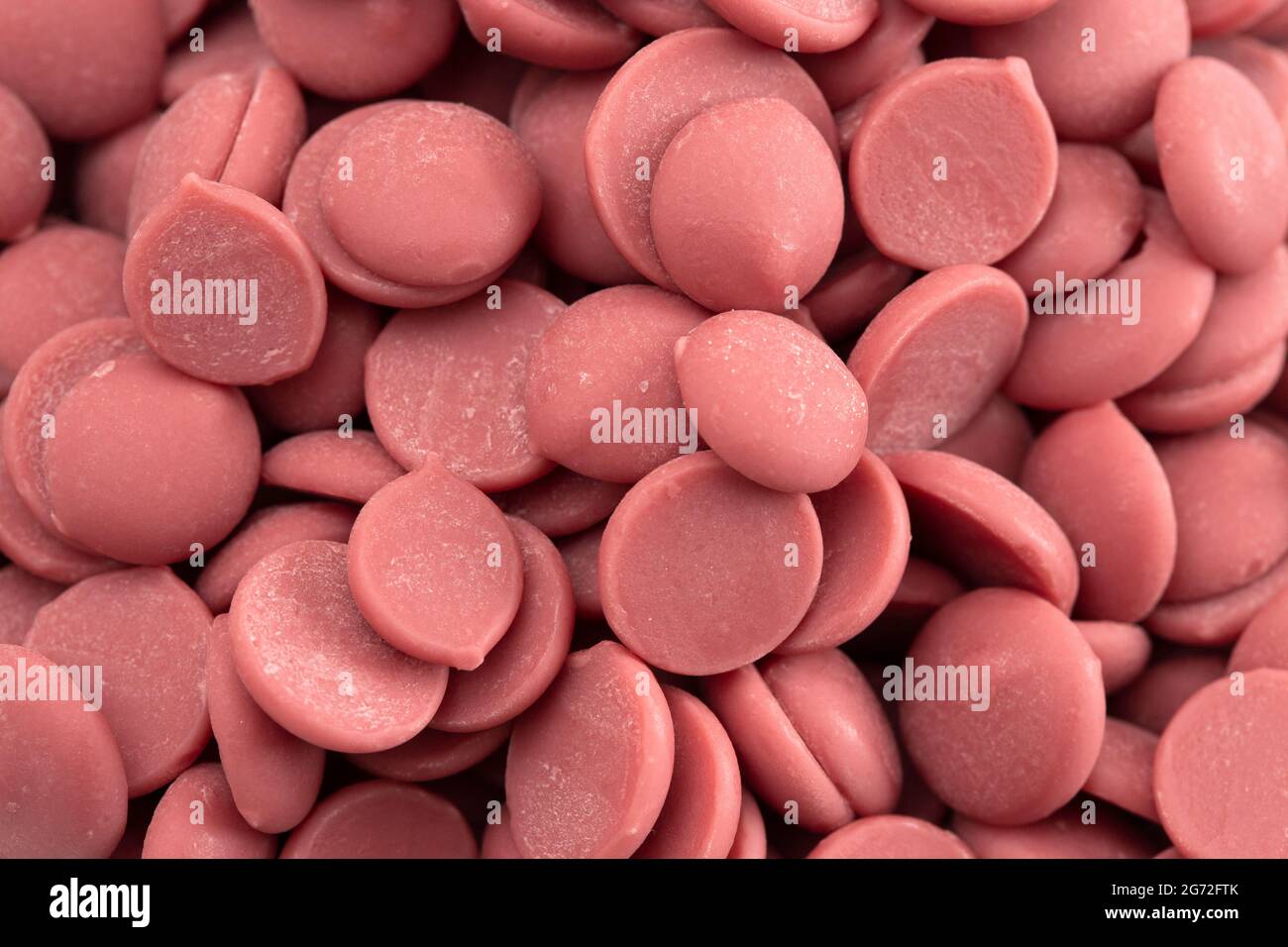 A Background of Authentic Ruby Chocolate Drops Stock Photo