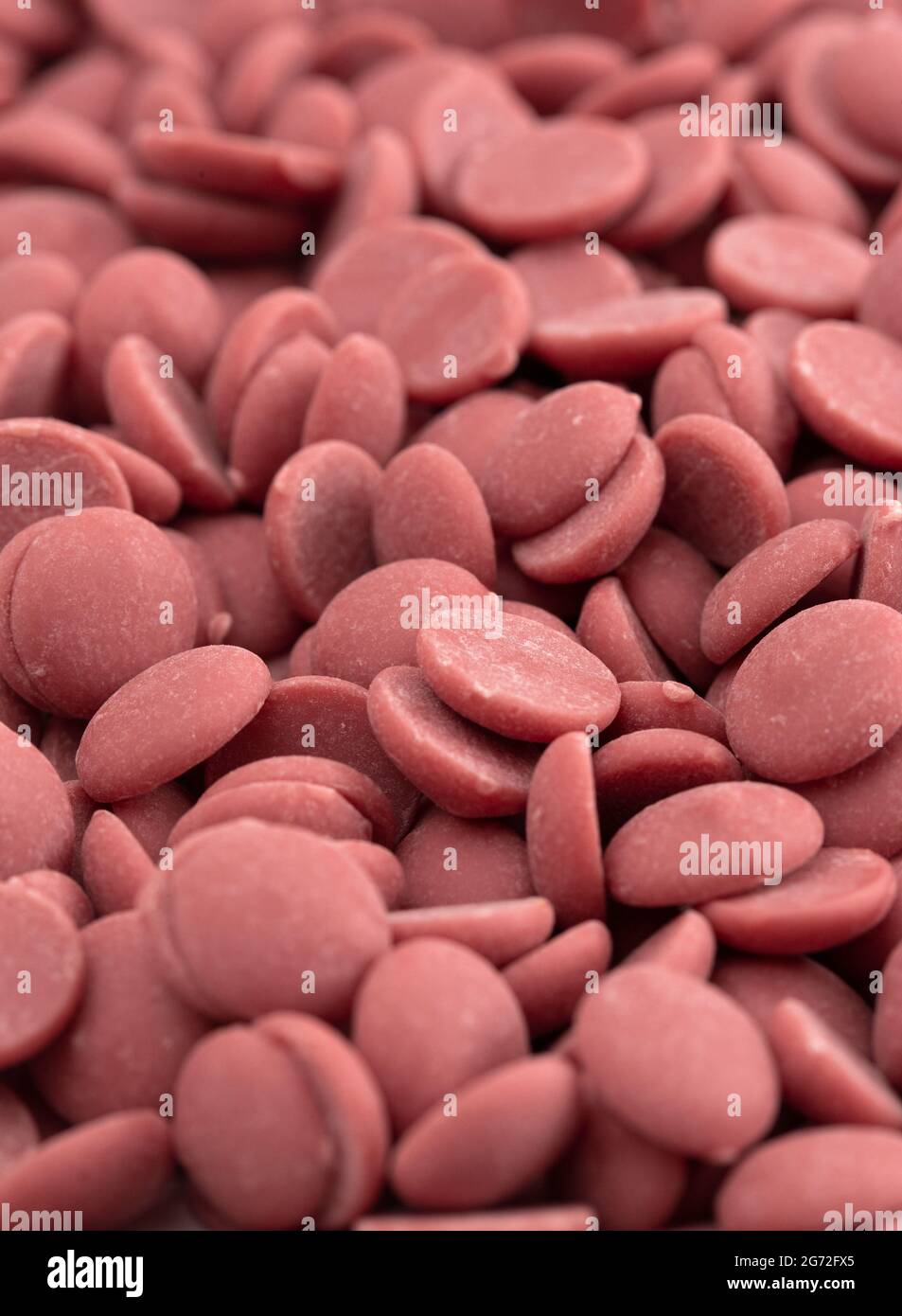 A Background of Authentic Ruby Chocolate Drops Stock Photo