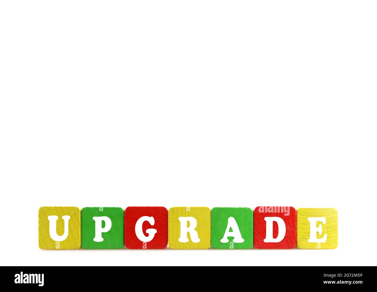 Word 'Upgrade' arranged of wooden colorful cubes isolated on white background Stock Photo
