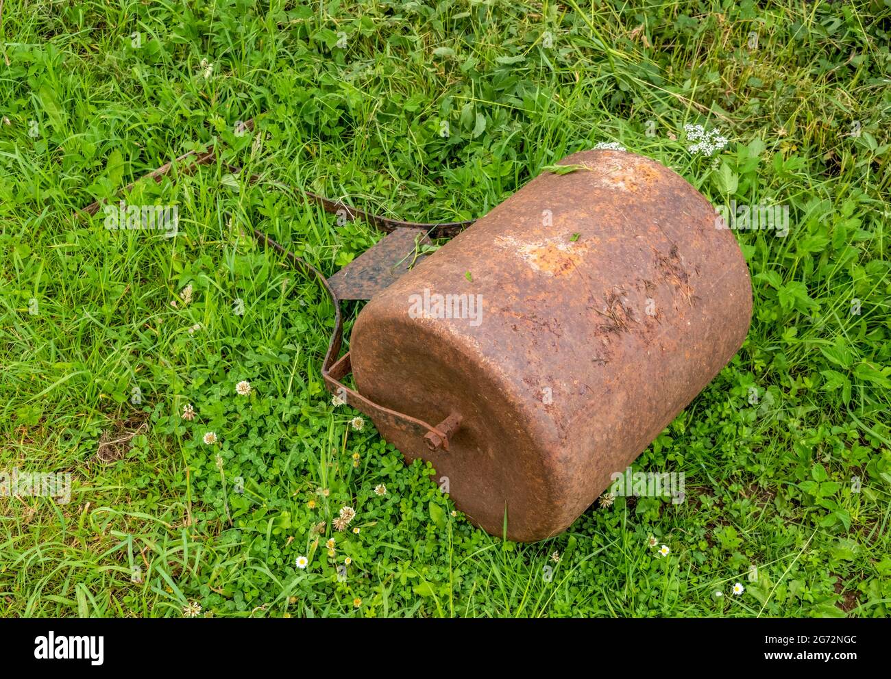 Rusty old grass lawn, bowling green roller. Forgotten. Stock Photo