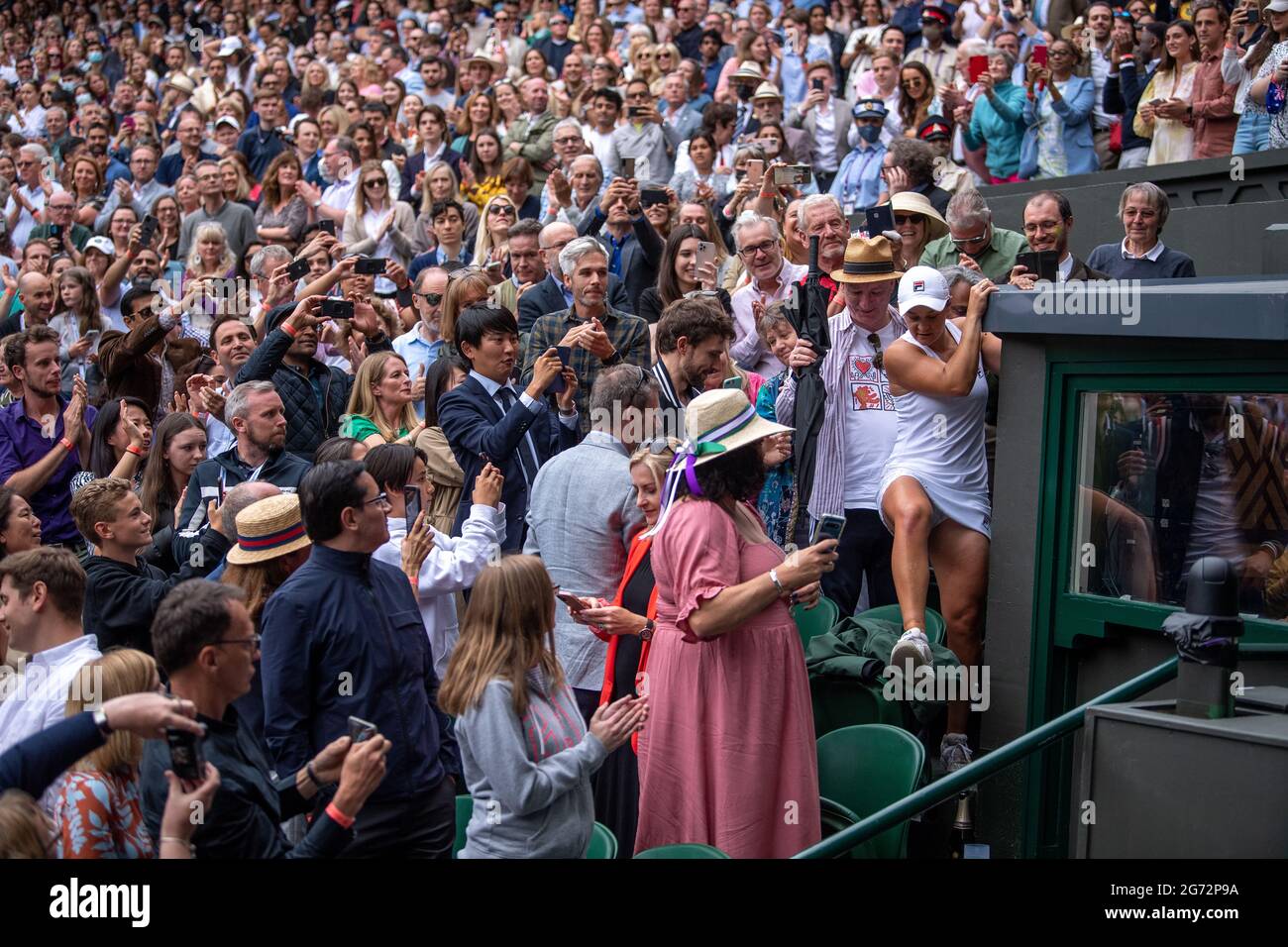 Ashleigh Barty returns to court after celebrating with her team after winning the ladies' singles final match against Karolina Pliskova on centre court on day twelve of Wimbledon at The All England Lawn Tennis and Croquet Club, Wimbledon. Picture date: Saturday July 10, 2021. Stock Photo