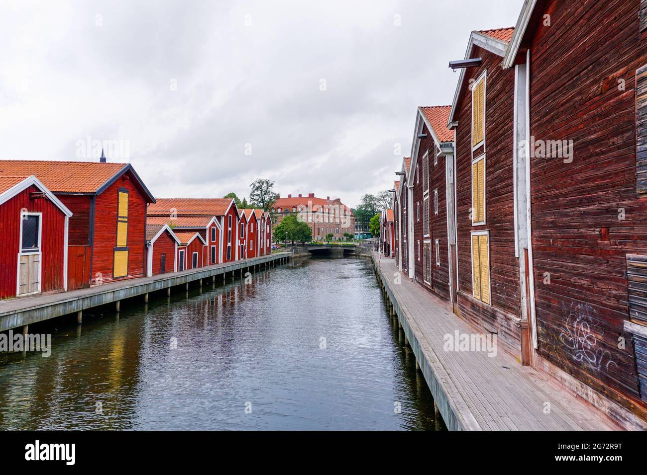 Hudiksvall, Sweden - 7 July, 2021: colorful wooden buildings line the canal in downtown Hudiskvall Stock Photo