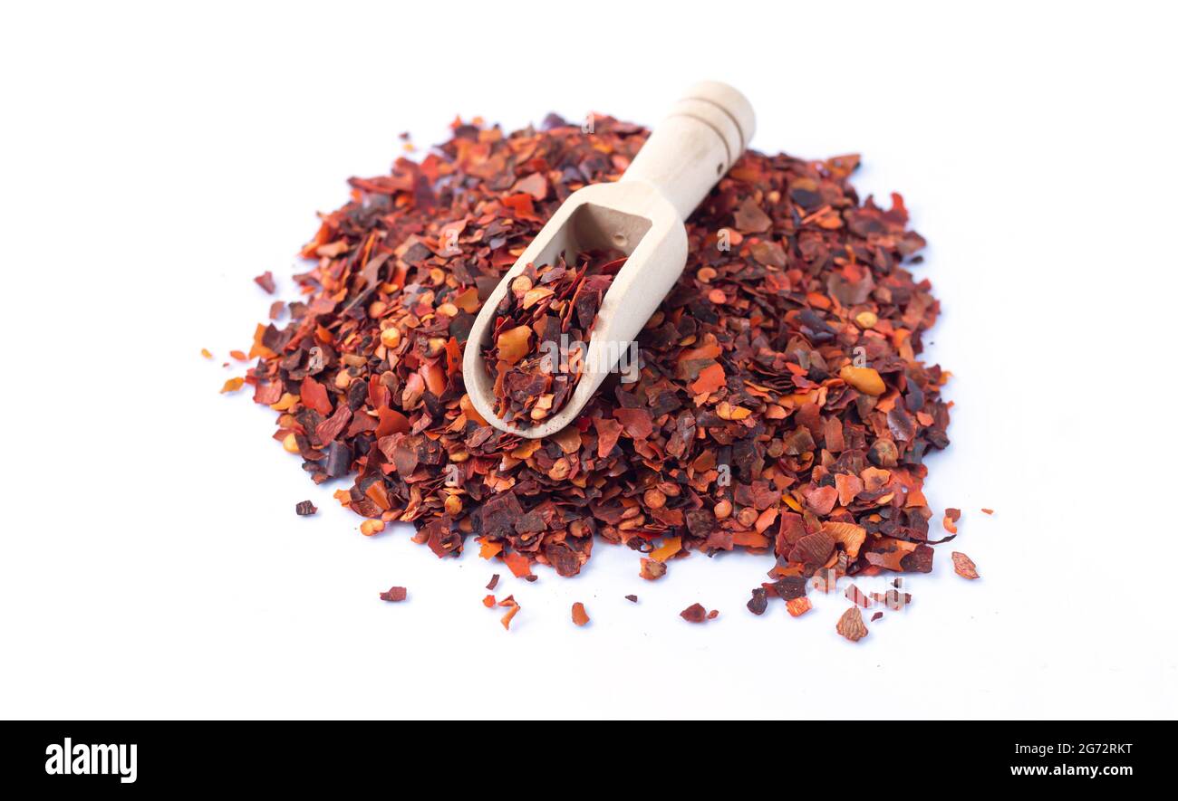 Pile of crushed red chilli pepper, dried cayenne pepper flakes isolated on white background
